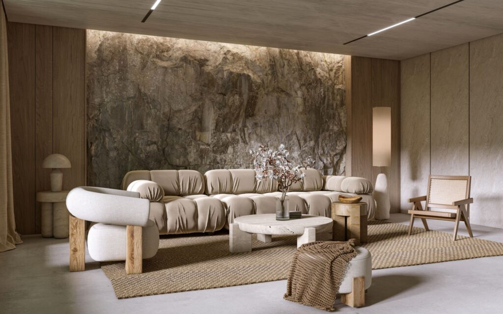 Helles wohnzimmer mit grosser natursteinwand, heller couch und natuerlicher lichtstimmung